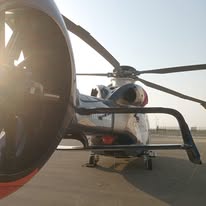 Airbus H160 helicopter on tarmac at sunrise